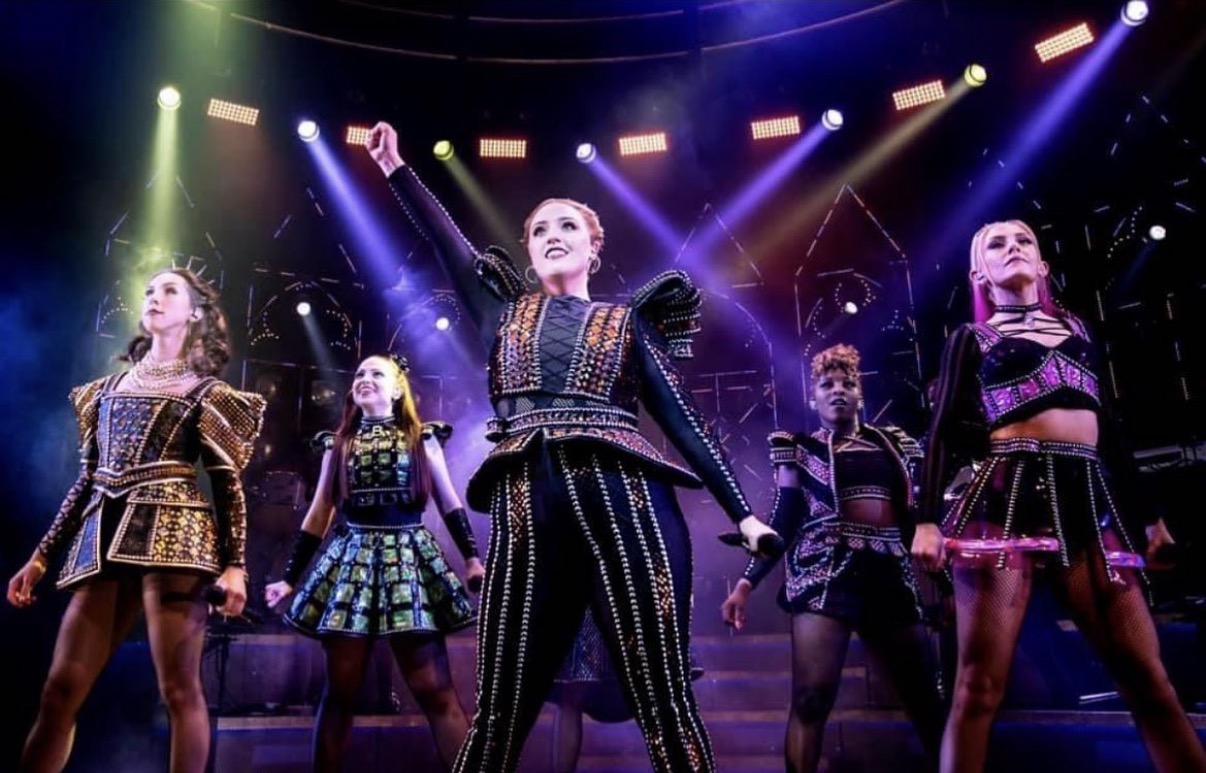 Harriet performing on stage in a West End musical.